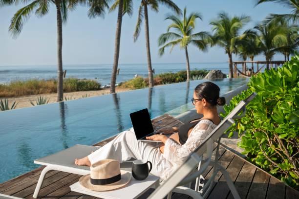 Pregnant woman on vacation working at the computer